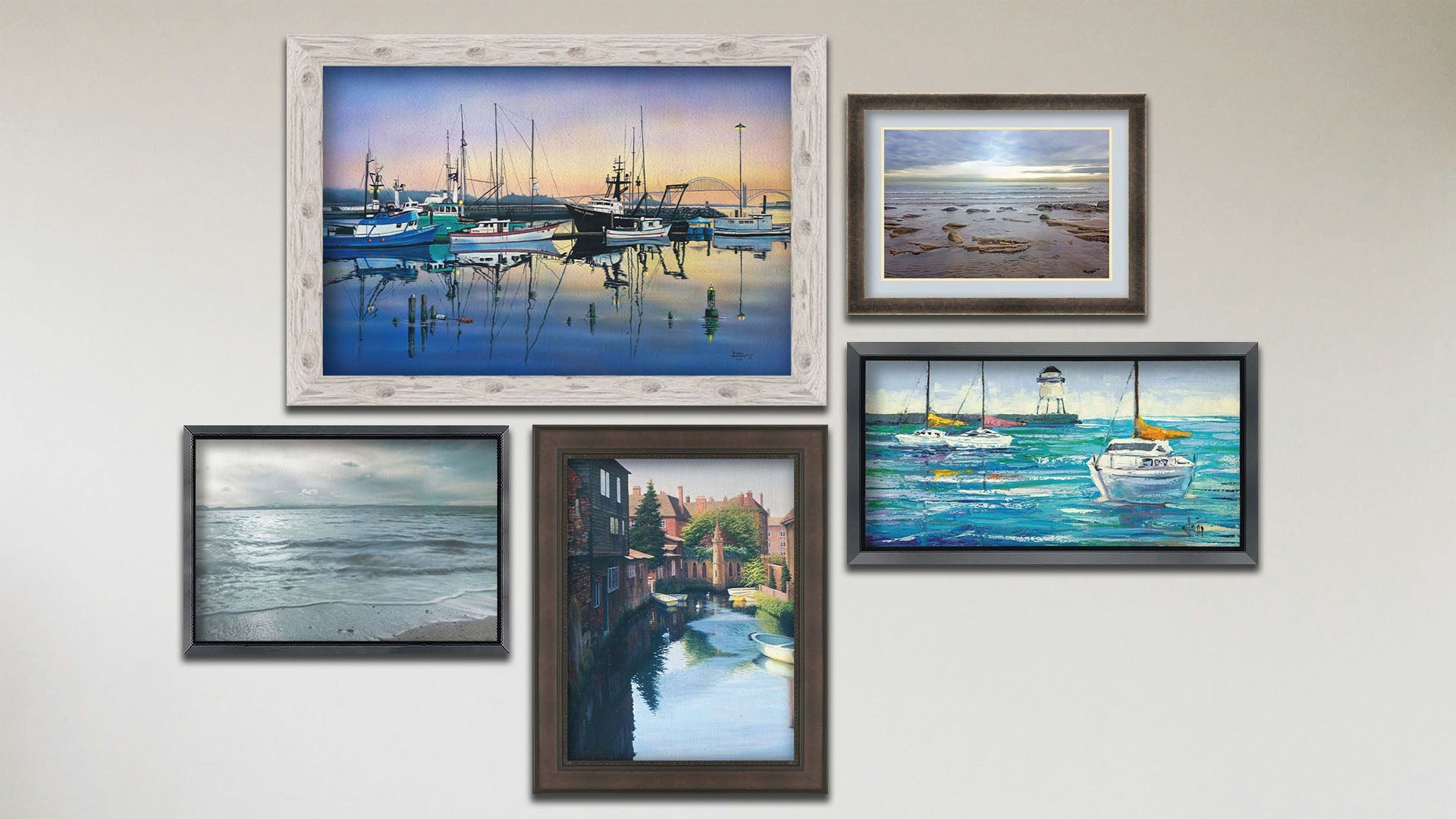 A collage of art in the designer Tranquil Harbor package, including three framed paintings of sailboats at the harbor, sailboats on the sea, and Canterbury Canal in England; a framed photograph of the sea from the beach; and a matted and framed photograph of the North Sea.