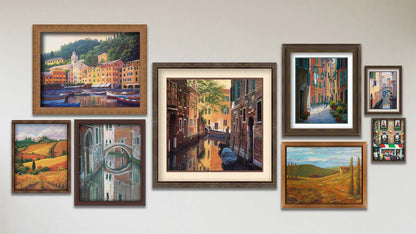 A collage of art in the designer Venetian Back Alley package, including four framed paintings of an Italian community, a bridge reflecting on the waters of a canal, colorful vineyards in Tuscany, and boats docked in the city of Portofino; three matted and framed paintings of clothes hanging over a canal in Italy, a streetlight over an alley, and a canal alleyway in Venice; and a float framed painting of a field in Tuscany.