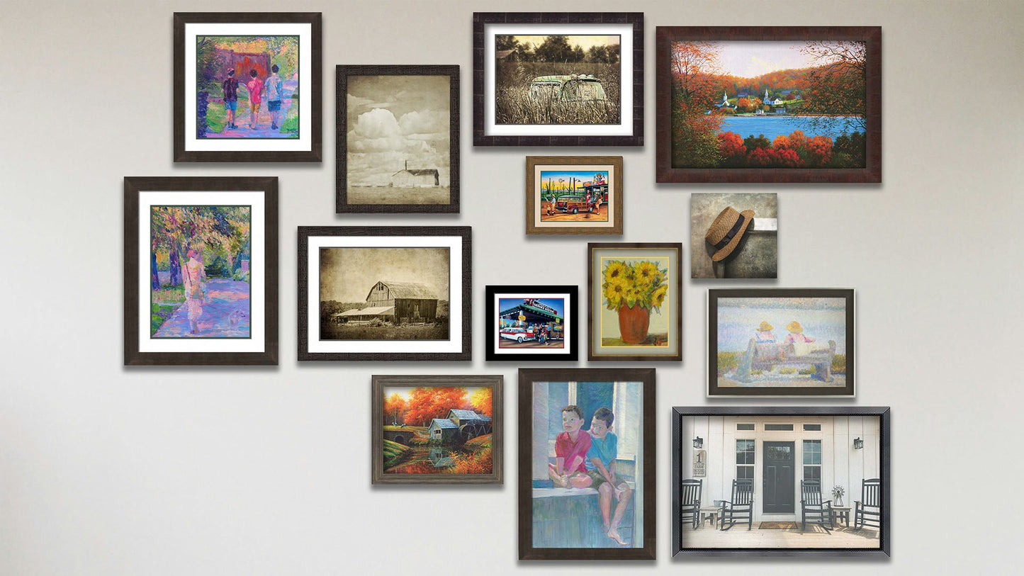 A collage of art in the designer Window to the Past package, including a canvas photo of a hat on a chair; four framed paintings of a little town by the water, people on a bench, kids on a window, and an old mill; two framed photos of a farm house porch and a barn; two matted and framed photos of a truck in a field and a barn; and five matted and framed paintings of a person walking their dog, three kids walking, a vase of sunflowers, a family lost on their road trip, and a family at a gas station.