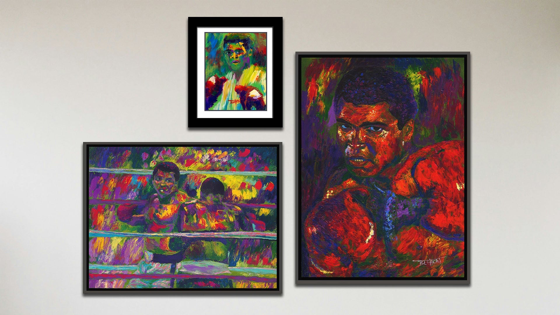 A collage of art in the luxury Muhammad Ali package, including a float framed painting of Muhammad Ali, a float framed painting of Muhammad Ali fighting Joe Frazier, and a matted and framed painting of Muhammad Ali.