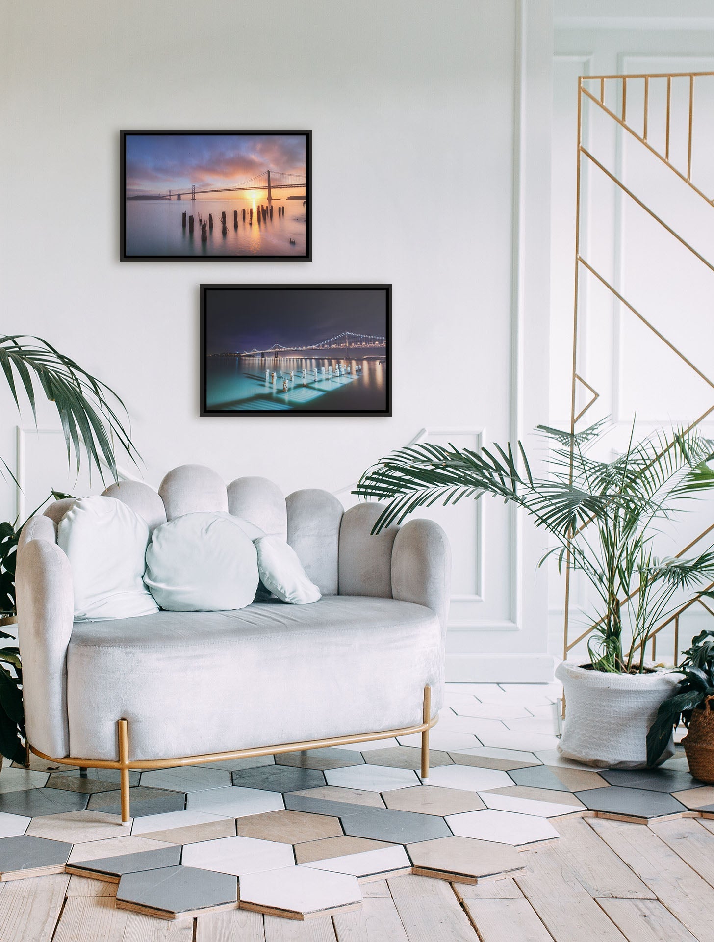 A tropical sea themed living room with palm plants and shell-themed furniture. Two float framed photographs overlooking the bridges of San Francisco at day and night hang on the wall.