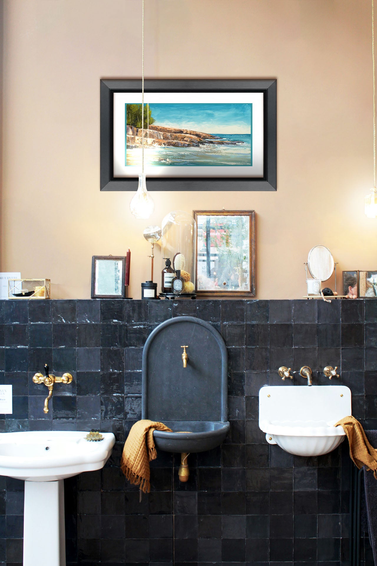 A painting hanging on a bathroom wall. A landscape painting of the area of Lake Superior known as "Artist's Point." A rocky outcrop borders the water of the lake. Printed on paper, matted, and framed.