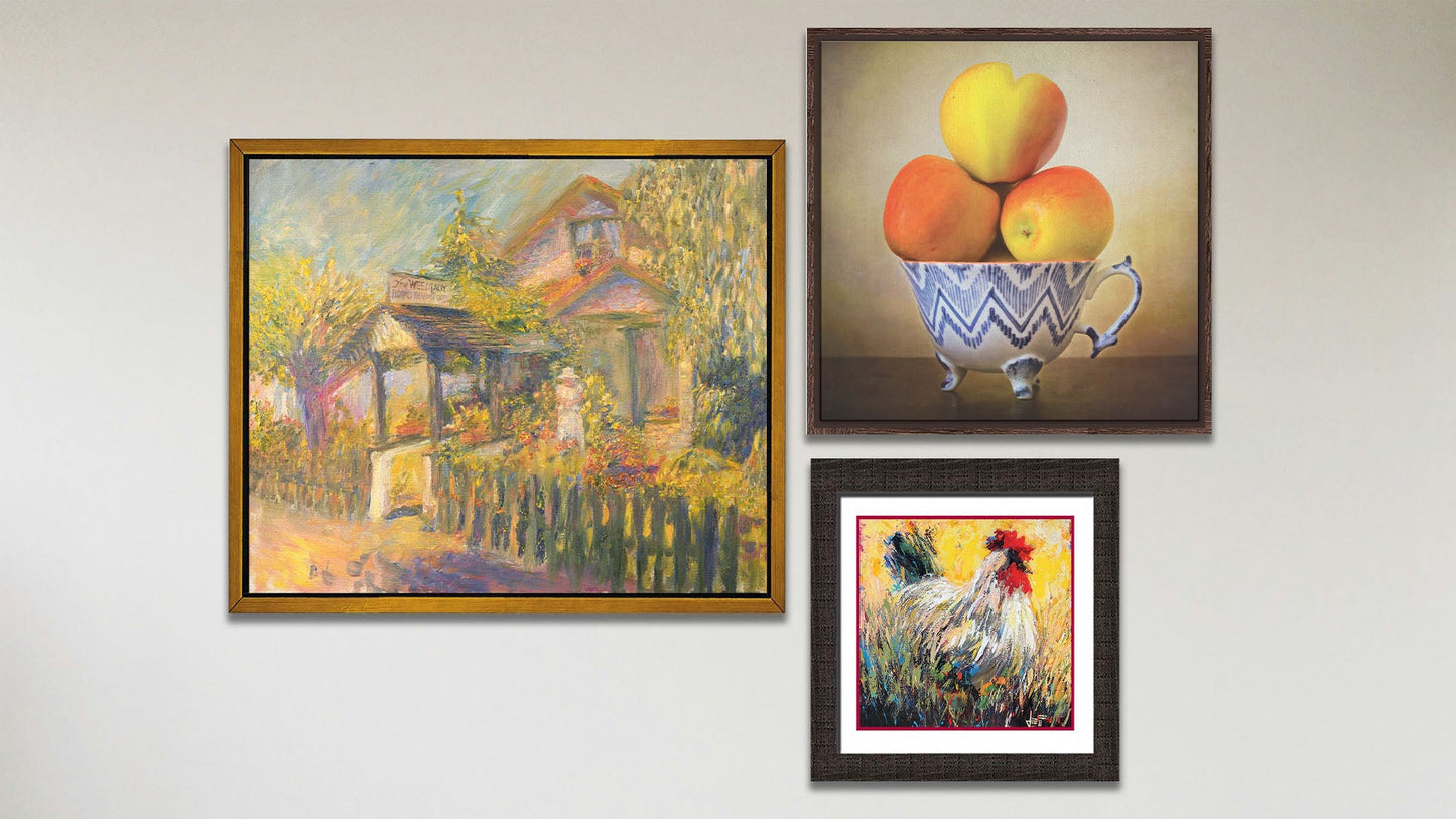 A collage of art in the luxury Place to Remember package, including a float framed painting of a garden store, a float framed photo still life of apples, and a matted and framed painting of a rooster.