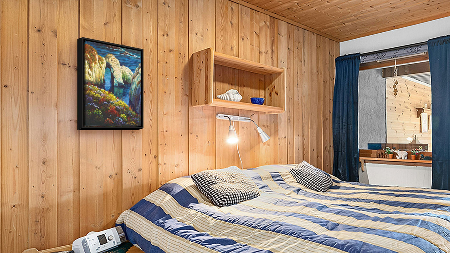 A seaside bedroom with light wood walls and blue and white furniture. A float framed painting of Point Lobos, Carmel-by-the-Sea, California, hangs on the wall.