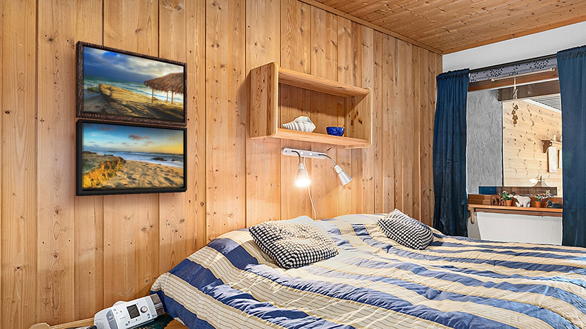 A seaside bedroom with light wood walls and blue and white furniture. Two float framed photographs of Windansea Beach hang on the wall.