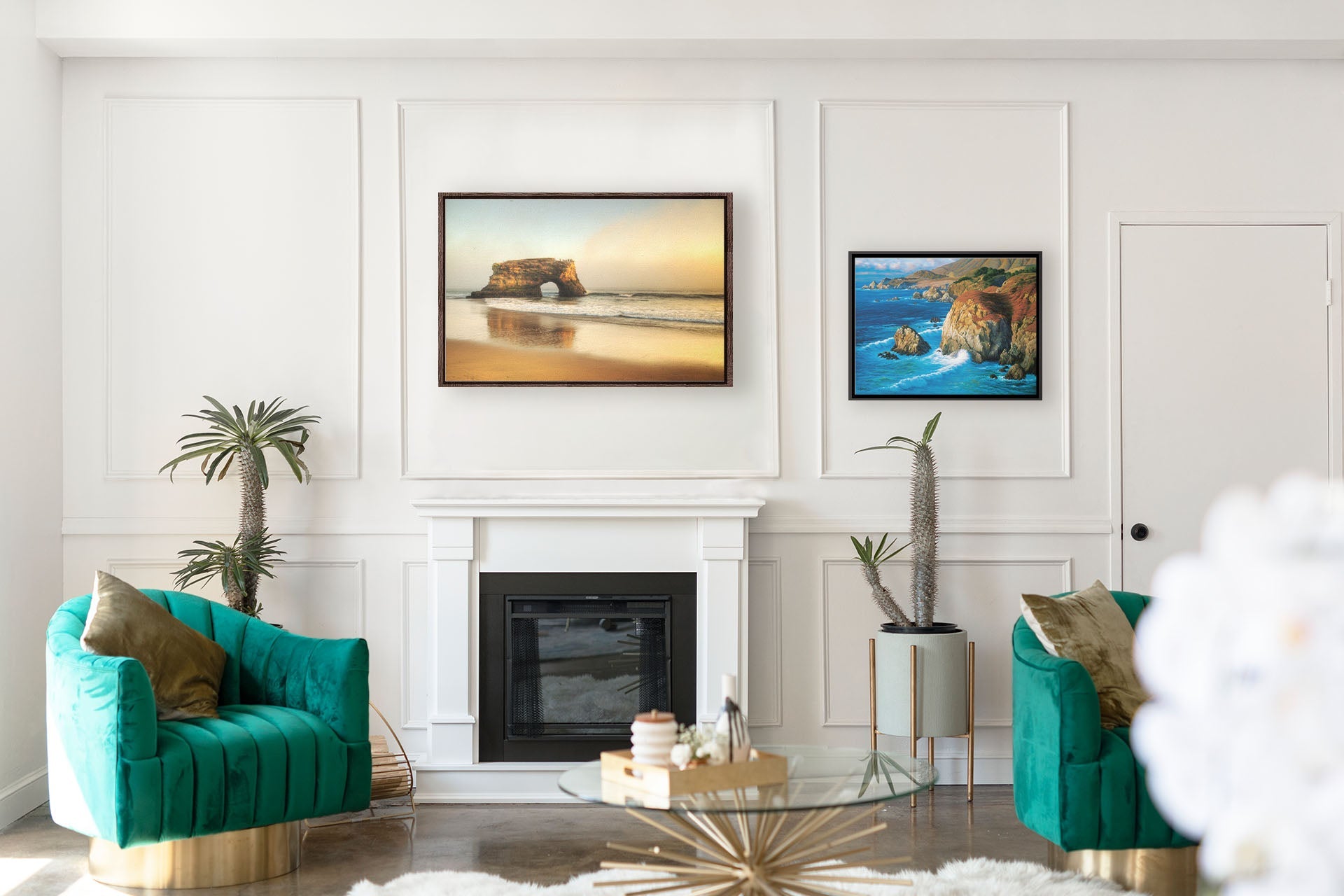 A tropical sea themed living room with highly designed white walls and teal furniture. Two float framed artworks hang on the wall– a photograph of Natural Bridges in Santa Cruz, California, and a painting of the view from Rocky Point at Big Sur, CA.