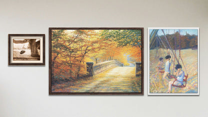 A collage of art in the luxury Swingers package, including a float framed painting of children playing on a swing set, a float framed painting of a road through an autumn forest, and a matted and framed sepia photo of a tire swing hanging from a broad tree.